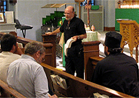 Eddie preaches with Bible in hand